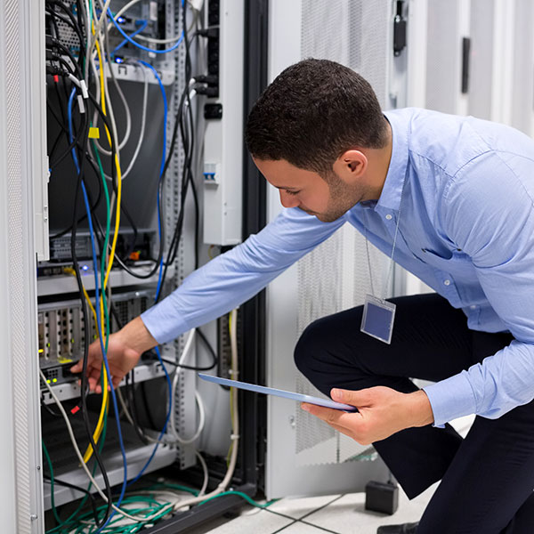 Data center technician installing server.