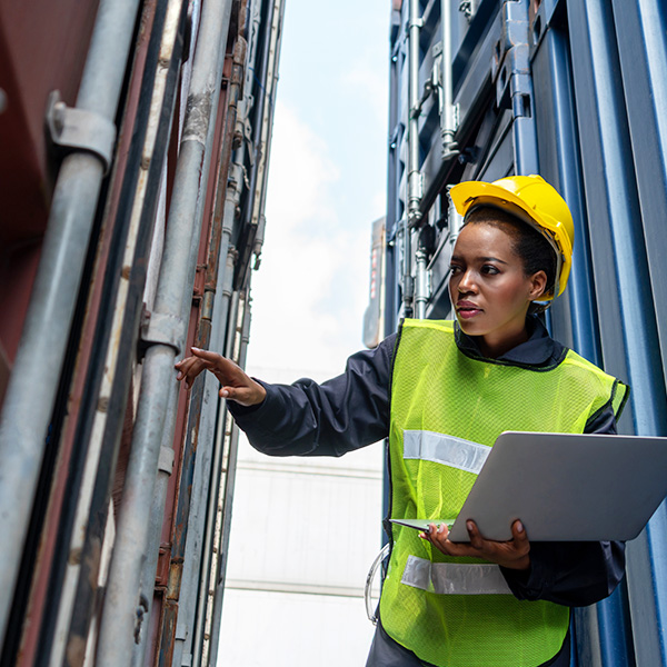 Female worker inspecting storage containers