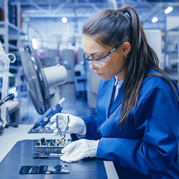 Woman assembling product in lab