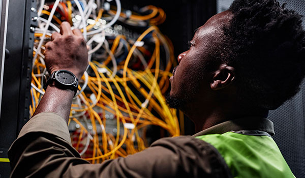 Male technician inspecting cables