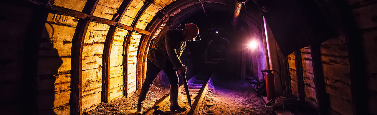 Miner working overhead light