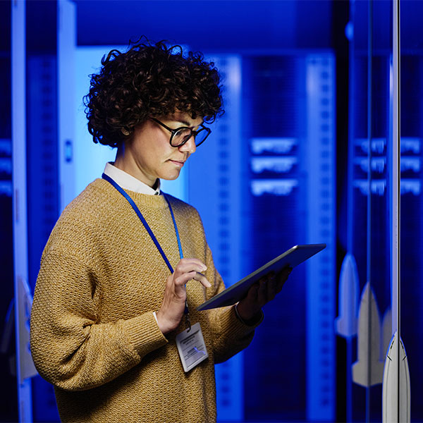 Woman with tablet in data center