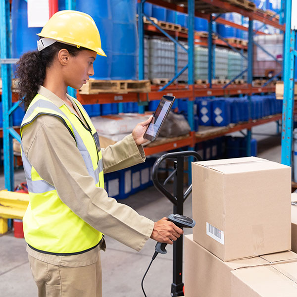 Woman scanning boxes in warehouse averted gaze